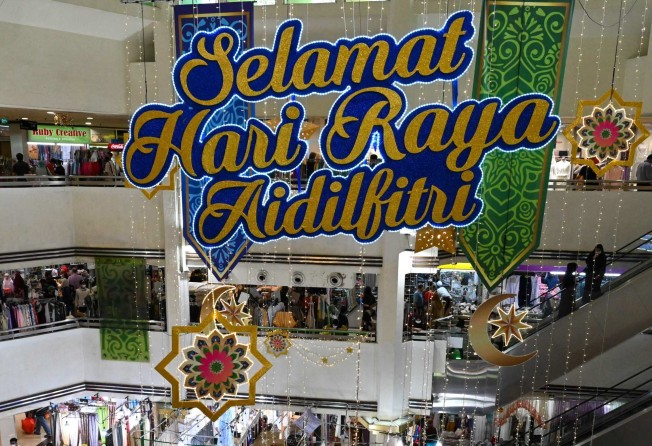 A festive greeting hangs in a shopping centre in Singapore on the eve of Hari Raya Aidilfitri, or Eid al-Fitr, marking the end of the Muslim fasting month of Ramadan. Photo: AFP