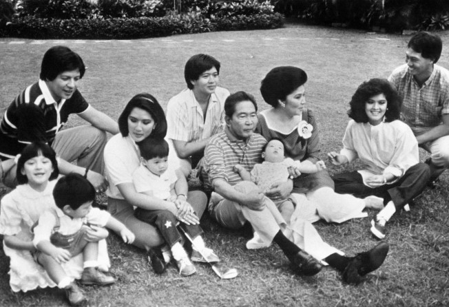 Philippines President Ferdinand Marcos (centre) with his family, including his wife Imelda (third from right)), eldest daughter Imee and her husband Tomas Manotoc (right), and his son Ferdinand Jnr (behind the president) in January 1986. Photo: AFP