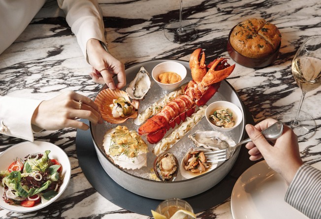 The seafood platter features marinated razor clams, crab, local clams, mussels and sea urchin on a bed of ice.