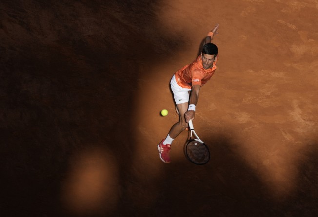 Serbia’s Novak Djokovic returns the ball to Switzerland’s Stan Wawrinka during their match at the Italian Open on May 12, 2022. Photo: AP