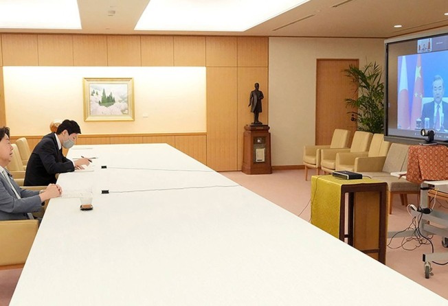 Japan’s Foreign Minister Yoshimasa Hayashi (left) speaks with his Chinese counterpart Wang Yi. Photo: AFP