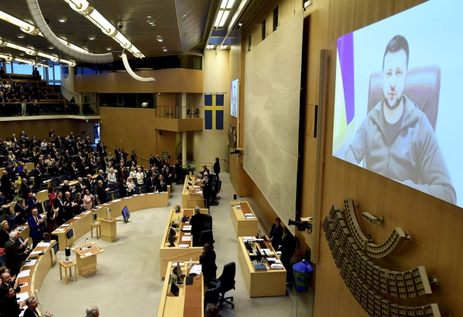 Volodymyr Zelensky receives a standing ovation as he addresses Sweden’s parliament via video link. Photo: AP