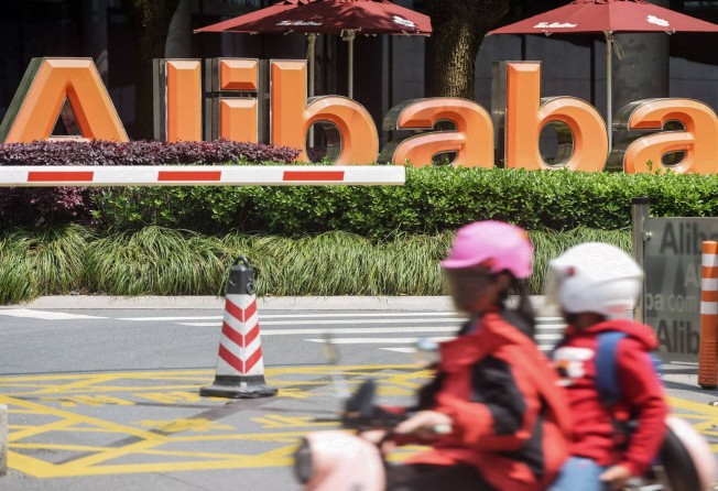 People commute past Chinese e-commerce giant Alibaba’s headquarters in Hangzhou in China’s eastern Zhejiang province on May 26. Photo: AFP