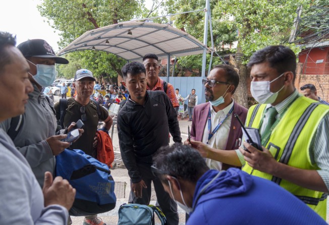 A team of climbers prepare for rescue operations in Nepal on Sunday after a small plane with 22 people on board went missing in the mountains. Photo: AP