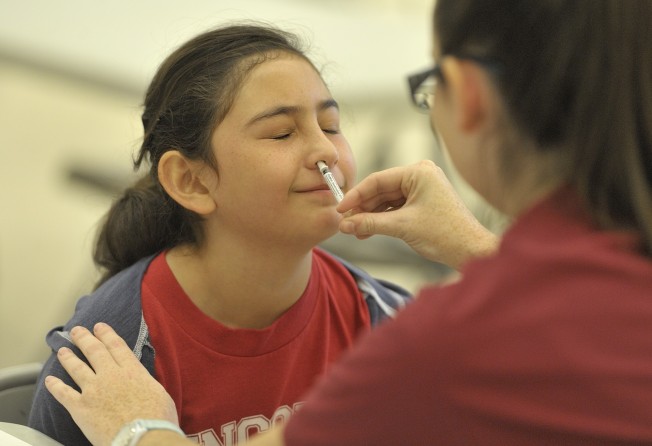 A child is given the FluMist vaccine at Lincoln Elementary School in Anaheim, in the US state of California, in 2015. Photo: Getty Images