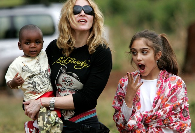 One-year-old David Banda with mum Madonna, returning for the first time to the Malawian orphanage that had once been his home. Photo: AP