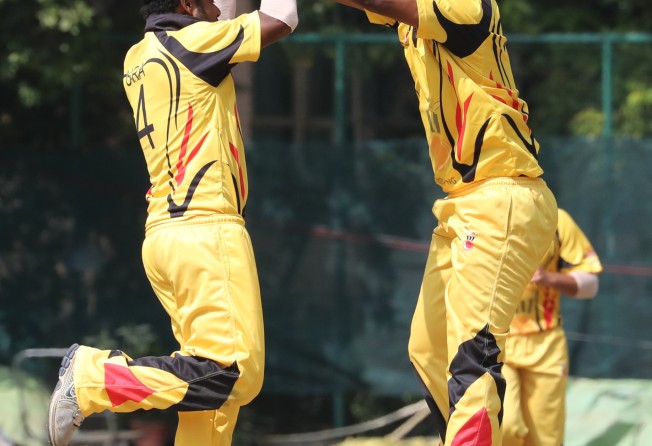 PNG’s Tony Ura (Left) and Assad Vala celebrate a wicket during a One Day International against Hong Kong at Tin Kwong Road Recreation Ground in 2016. Photo: Edward Wong