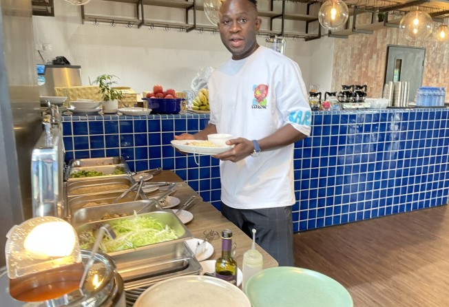 Striker Alex Akande enjoys food in Kitchee’s new sports nutrition canteen. Photo: Chan Kin-wa