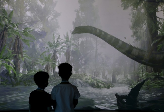 Boys look at a sauropod. Photo: Nora Tam