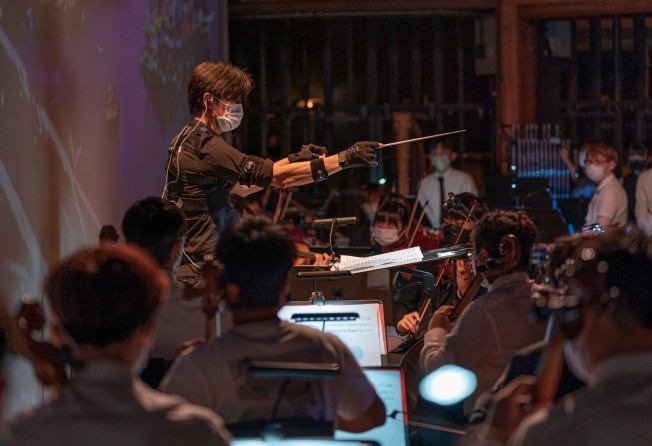Music director Poon wears a body sensor during a rehearsal for the concert. Photo: Hong Kong Baptist University