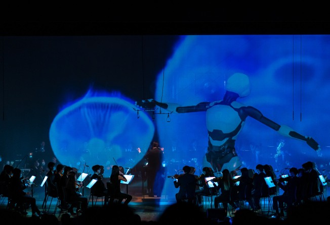 Hong Kong Baptist University’s symphony orchestra was joined by a 320-voice choir created through artificial intelligence (AI), and several AI ballet dancers who twirled on a big screen. Photo: Hong Kong Baptist University