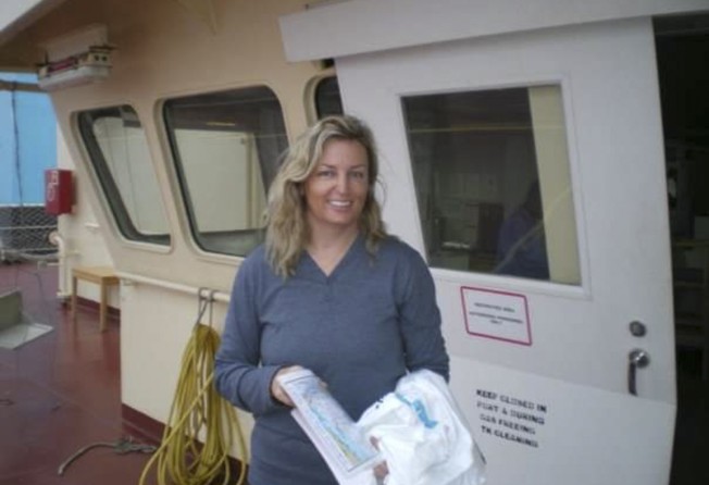 Carolyn Lee after being rescued while sailing from the Philippines to Hong Kong. She is holding a souvenir T-shirt from Maersk. A tanker from the Danish shipping company saved her, her family and crew. Photo: Carolyn Lee