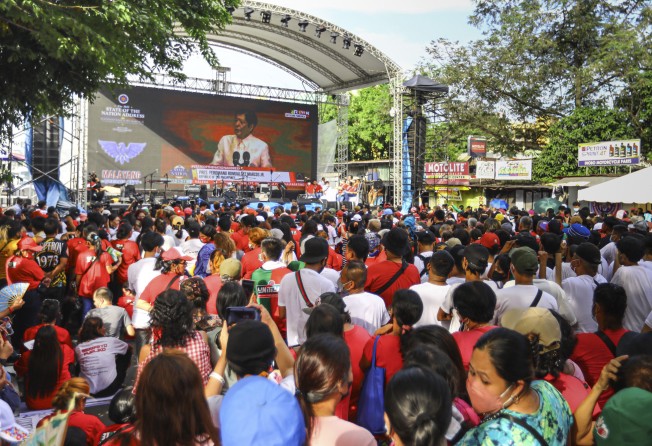 Supporters of President Ferdinand Marcos Jnr watch his speech outside the House of Representatives Congress in Quezon City. Photo: AP