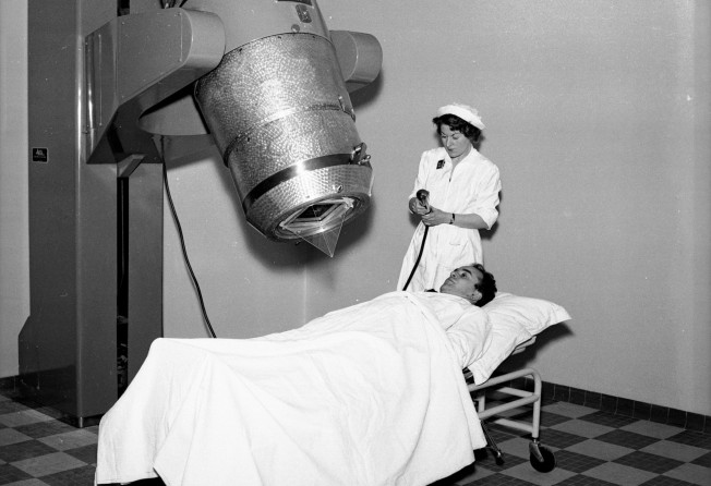 A cobalt “bomb” treatment of a patient at the Hartmann Clinic in Paris in the 1950s. The apparatus uses a radioactive isotope of Cobalt 60 to check the growth of cancer cells in patients. Photo: Getty Images