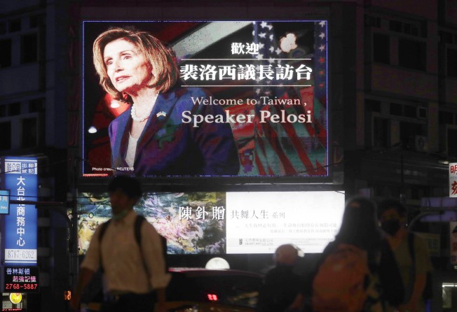 People walk past a billboard welcoming US House Speaker Nancy Pelosi in Taipei, Taiwan on Tuesday. Photo: AP