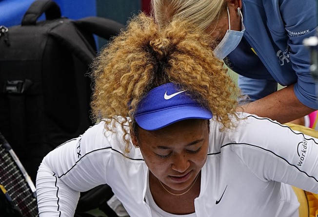 Naomi Osaka gets treatment by a therapist during a match against Kaia Kanepi. Photo: USA TODAY Sports