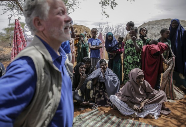 World Food Programme chief David Beasley, left, meets with villagers in northern Kenya on Friday. Photo: AP