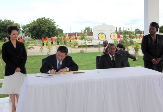 Chinese President Xi Jinping signs a condolence book for Chinese workers on the Tazara, as then Tanzanian president Jakaya Kikwete and the respective first ladies look on, at a memorial in Dar es Salaam in March 2013. Photo: AFP