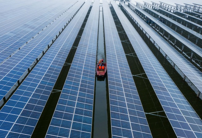 Staff members inspecting a solar power plant in Wenzhou, Zhejiang province. Photo: Xinhua