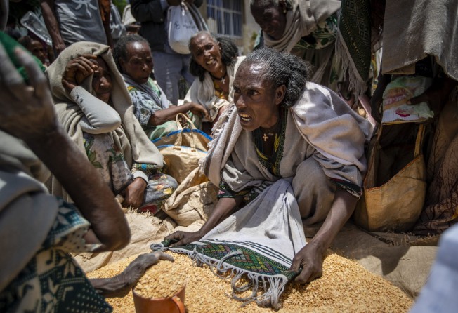 An Ethiopian woman argues with others over the allocation of yellow split peas after it was distributed by the Relief Society of Tigray in the town of Agula, in the Tigray region of northern Ethiopia in May 2021. Photo: AP