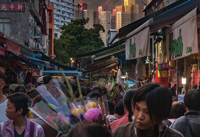 An image from Jacquet-Lagrèze’s latest collection shows a busy Hong Kong market with Lion Rock in the background. Photo: Romain Jacquet-Lagrèze/Blue Lotus Gallery