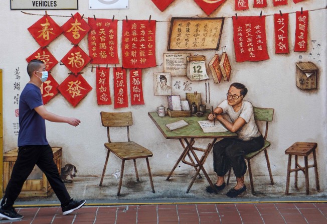 A man walks past a mural in Chinatown in Singapore in 2020. Photo: AFP