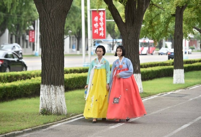 Two women wear traditional hanbok dresses as they walk on a street in Pyongyang. North Korea has repeatedly rejected accusations of human rights abuses and criticised UN investigations into rights as a US-backed scheme to topple the state. Photo: AFP