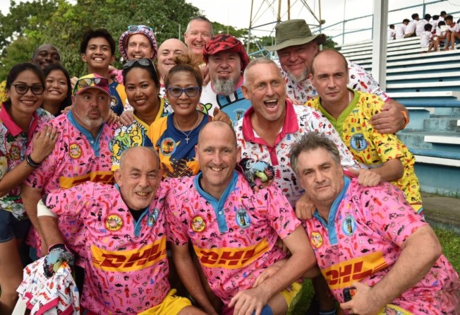 Tournament director Andrew Green (middle front) with the Pot Bellied Pigs Football Club. Photo: Ross Bendix