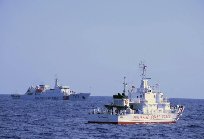 A Chinese coastguard ship (left) shadows a Philippine coastguard vessel while patrolling the Scarborough Shoal in the South China Sea in March 2022. Photo: AFP/Philippine Coast Guard
