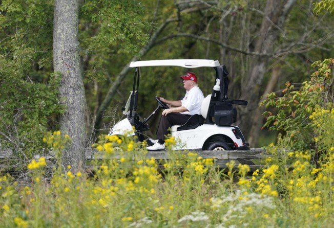 Donald Trump rides around his golf course at Trump National Golf Club in Sterling, Virginia. Photo: AP