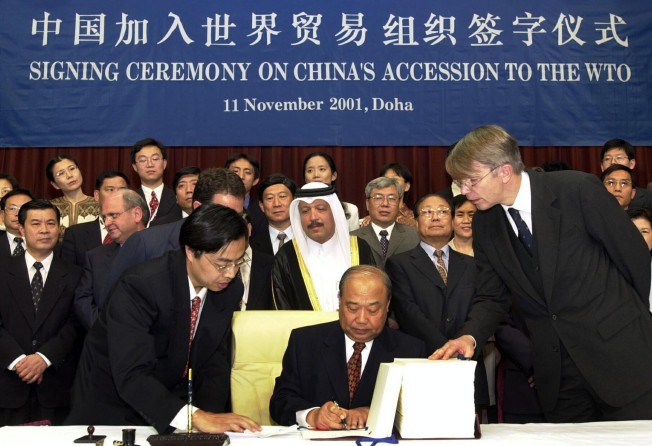 Shi Guangsheng, then Chinese trade minister, signs a document confirming China’s membership of the World Trade Organization, on November 11, 2001, in Doha, Qatar. Photo: AP