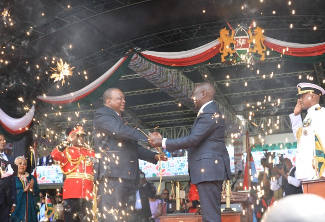 Kenya’s former president Uhuru Kenyatta (left) handing President Ruto a ceremonial sword during swearing-in ceremonies on Tuesday in Nairobi. Photo: DPA