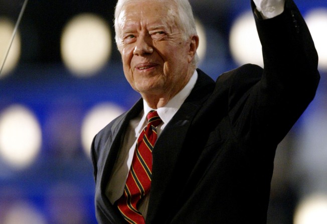 Former President Jimmy Carter waves to the delegates after being introduced at the Democratic National Convention at the Fleet Center in Boston, in 2004. Photo: Reuters