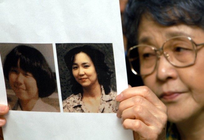 Sakie Yokota in 2002 with a picture of her daughter Megumi aged 13 and another allegedly of her as an adult, handed over by North Korea to a Japanese fact-finding mission. Photo: AP