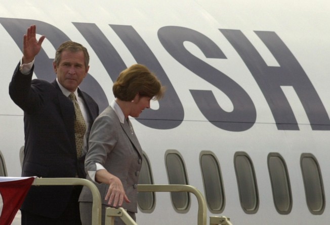 George W. Bush waves as he and his wife Laura leave their campaign plane at the Northeast Philadelphia Airport, in 2000. Photo: AP