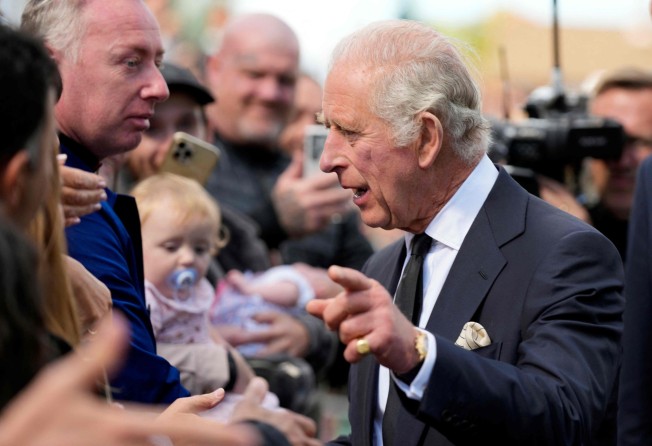 Britain’s new king, Charles III, interacts with the public in Cardiff, Wales on Friday. His mother’s funeral will take place on Monday. Photo: AFP