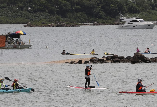 People enjoy canoeing and paddle boarding in better weather that Sunday’s. Photo: Dickson Lee.