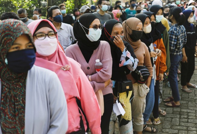 Women in Jakarta, Indonesia, queue to receive Covid-19 vaccine shots in 2021. Photo: Reuters