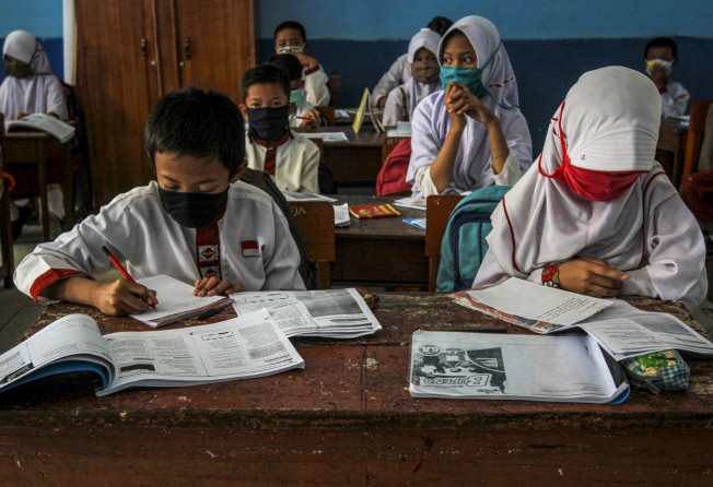 Thousands of schools in Indonesia make it compulsory for female students, even those who are not Muslim, to wear a headscarf. File photo: AFP