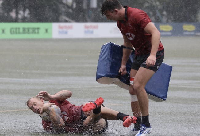 Hong Kong’s sevens captain Max Woodward (left) and Liam Doherty during training at a soggy King’s Park. Photo: Jonathan Wong