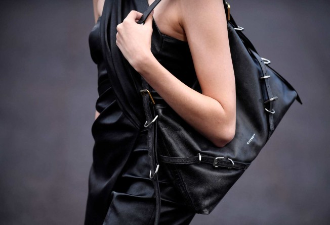 A model slings a black strappy bag over the shoulder for Givenchy during the spring-summer 2023 fashion show as part of the Paris Womenswear Fashion Week, in Paris, on October 2. Photo: AFP