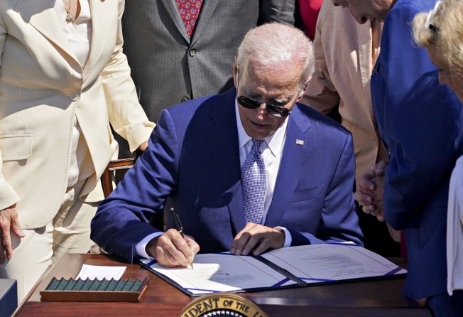 US President Joe Biden signs the Chips and Science Act of 2022 during a ceremony on the South Lawn of the White House on August 9. Photo: Bloomberg
