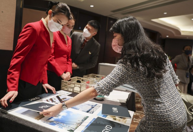 A job seeker speaks to Cathay Pacific flight attendants at a special recruitment day on Friday. Photo: Yik Yeung -man.