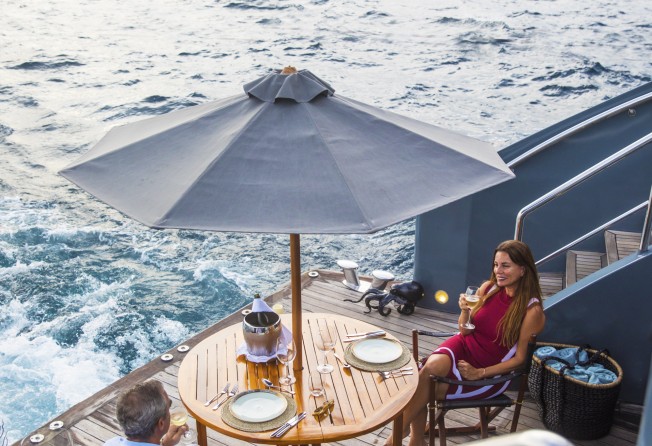 Guests eat aboard the yacht while taking in arresting views. Photo: Aqua Blu