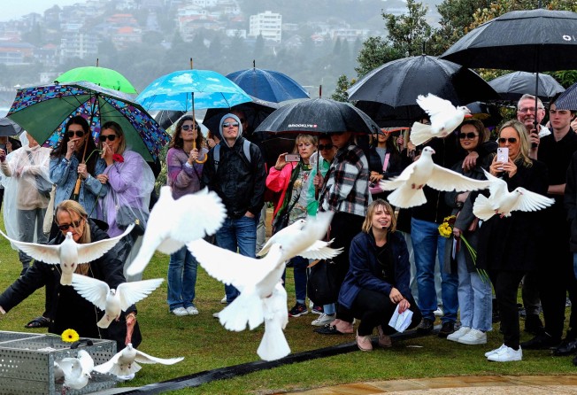 Doves are released during a ceremony to mark the 20th anniversary of the Bali bombings, at Coogee Beach in Sydney on Wednesday. Photo: AFP