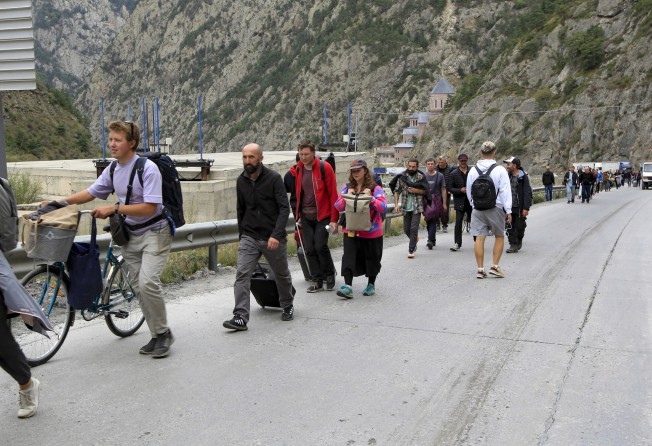 People walk toward the border crossing between Georgia and Russia as they leave Russia after Moscow announced a partial military mobilisation, September 28. Photo: Getty Images