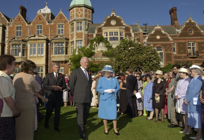 Britain’s Queen Elizabeth hosts a garden party at Sandringham House in Norfolk in 2002. Photo: Getty Images