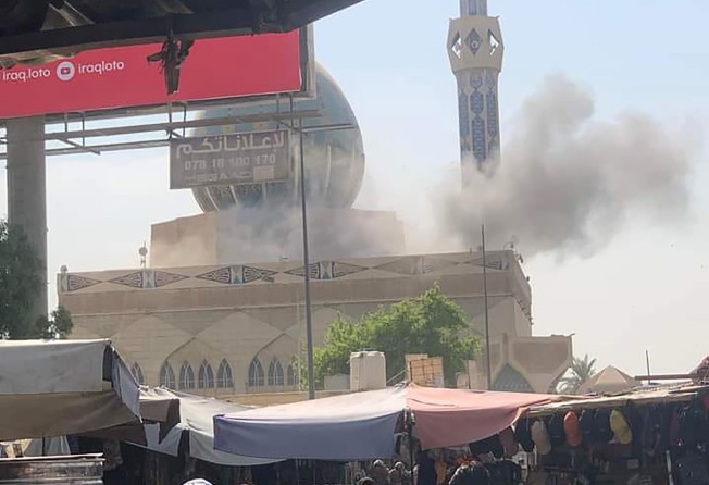 Smoke rises after a rocket attack in Baghdad, Iraq, on Thursday. Photo: AFP