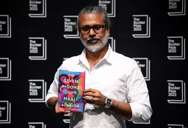 Sri Lankan author Shehan Karunatilaka holds his book The Seven Moons of Maali Almeida at the Shaw Theatre in King’s Cross in London on Friday. Photo: AFP