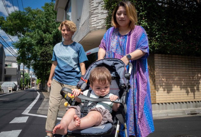 Mamiko Moda (L) and Satoko Nagamura walk with their son, who was conceived with donated sperm. Photo: AFP